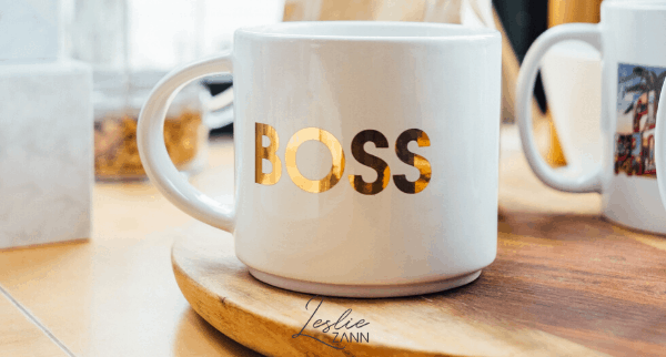 white coffee cup with word BOSS written in gold letters